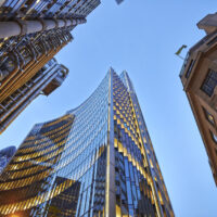 Three different kind of architecture with commercial office buildings exterior. Evening view at bottom skyscrapers.